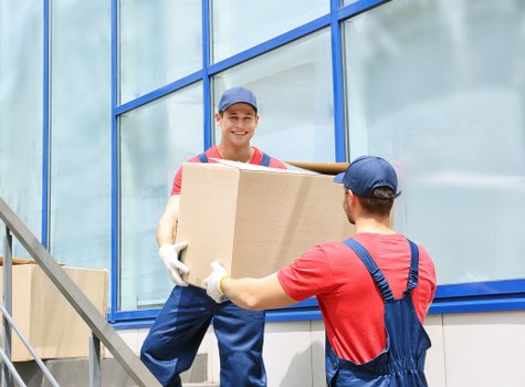 Man and van loading boxes in Whitechapel street setting