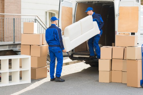 Packed office equipment and business furniture ready for a local move