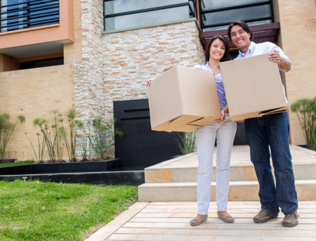 Careful unpacking of household boxes in a Whitechapel flat